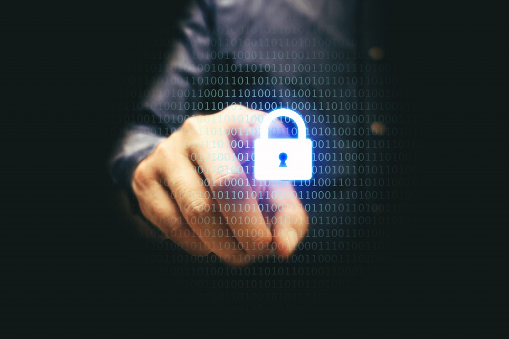 Man pointing a padlock with codes