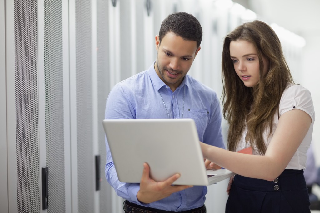 Man and woman looking at laptop