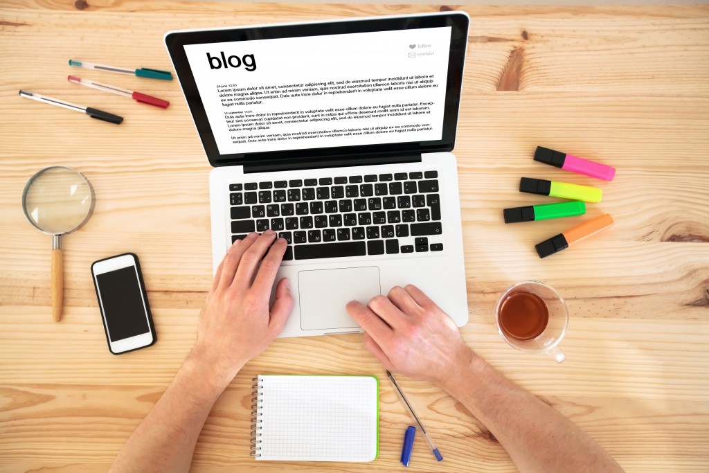 a person writing a blog on laptop