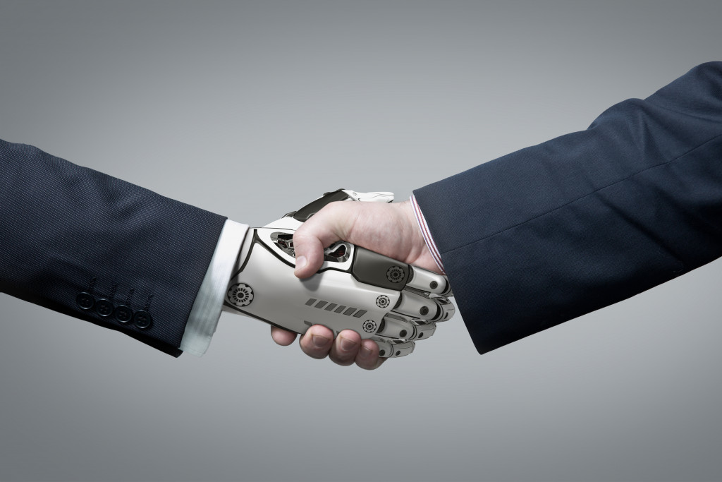 robot and a man shaking hands